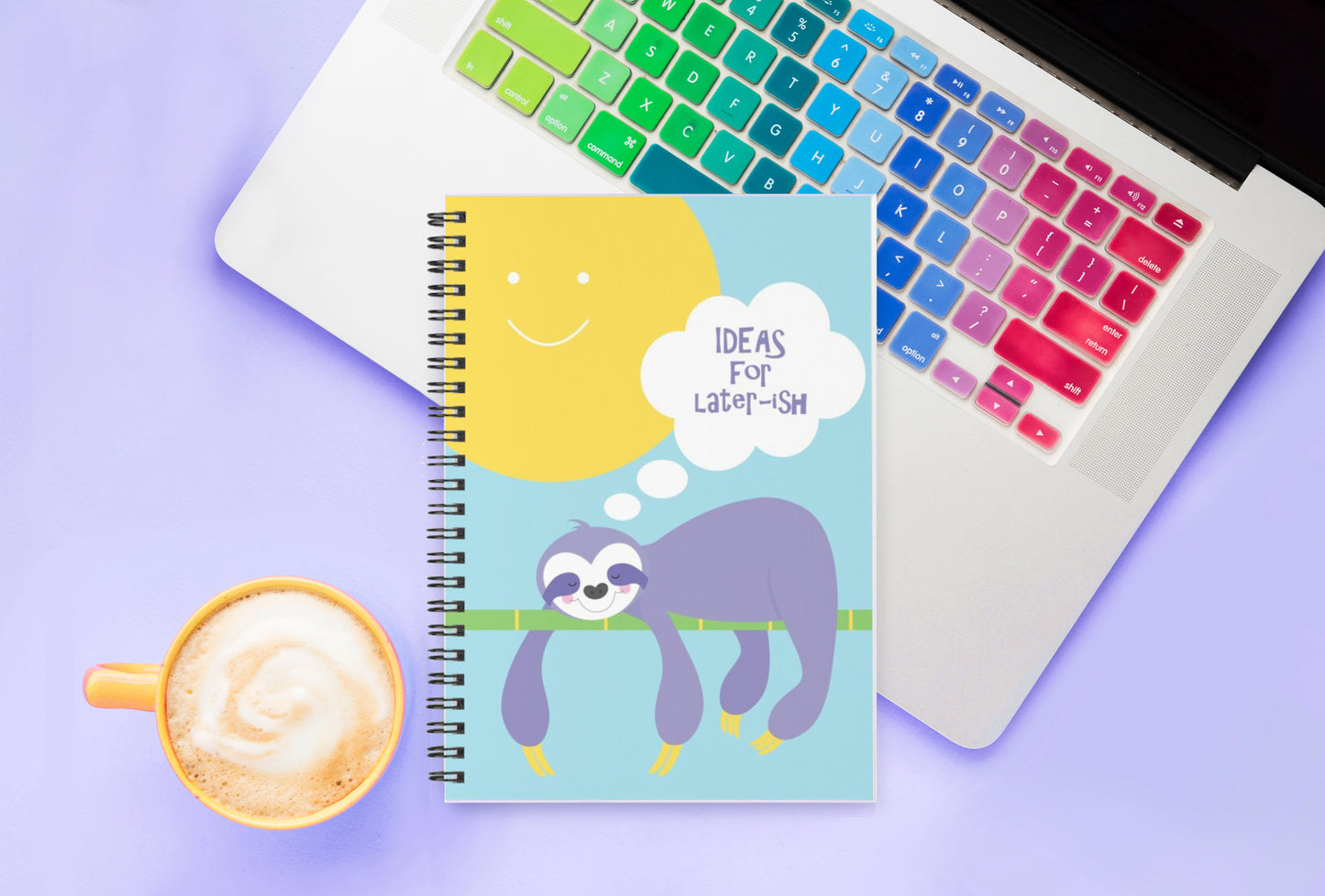 colourful lazy sloth on the cover design this spiral notebook on a laptop