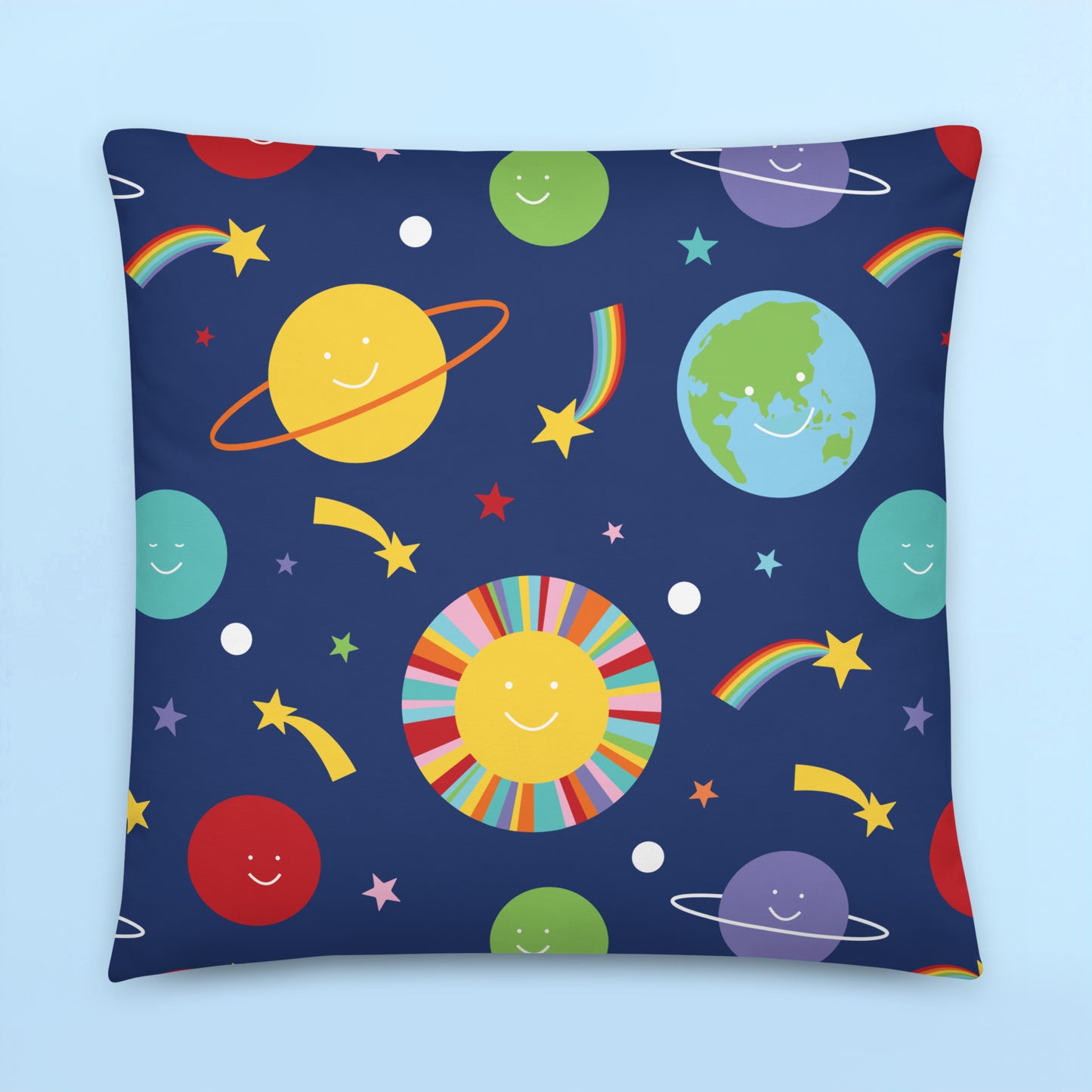 Colourful smiling planets cushion cover with rainbow stars and playful retro space design on navy background for kids bedroom decor.