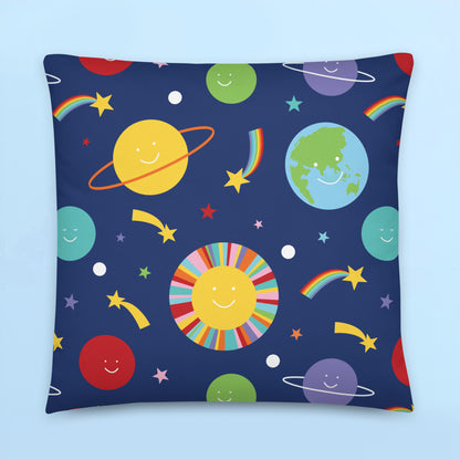 Colourful smiling planets cushion cover with rainbow stars and playful retro space design on navy background for kids bedroom decor.