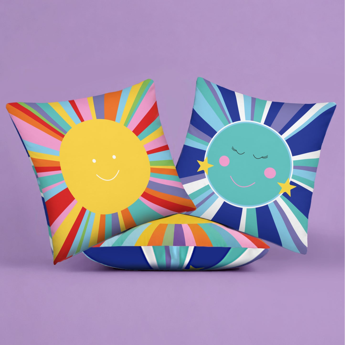 Colorful pillows with sun and moon designs front and back on a purple background