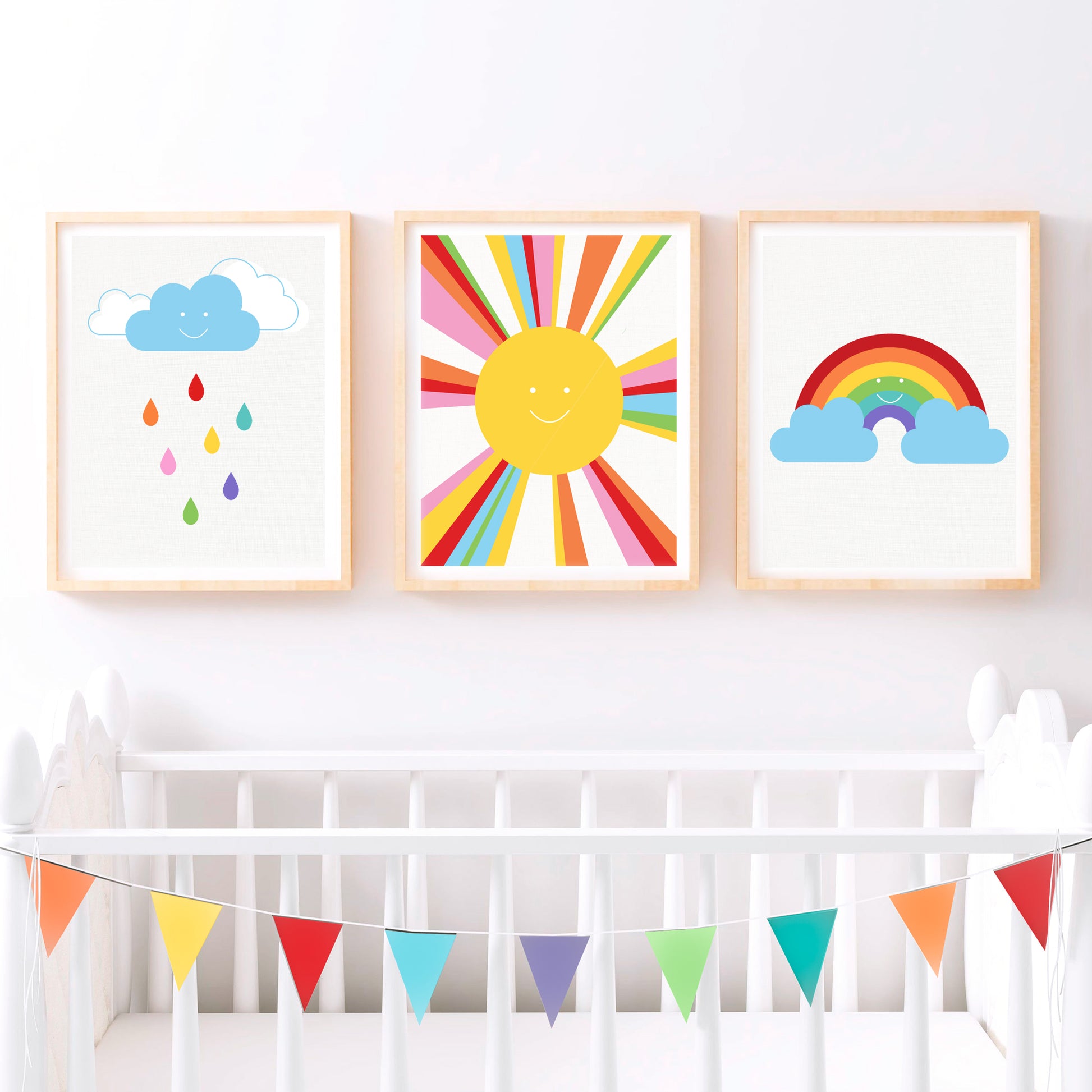 set of three fun weather themed kids art prints - smiling rain, sun and a rainbow above a cot