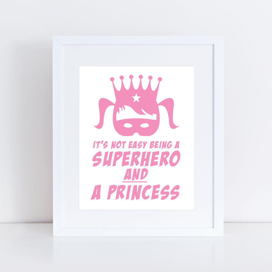 print of a girls face with pigtails, wearing mask and crown and the words it's not easy being a superhero and a princess