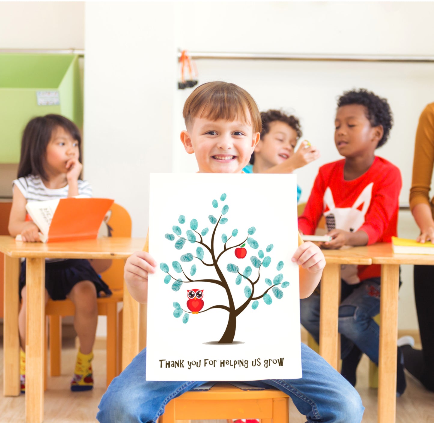 child in classroom holding a Custom teacher gift fingerprint tree with owl