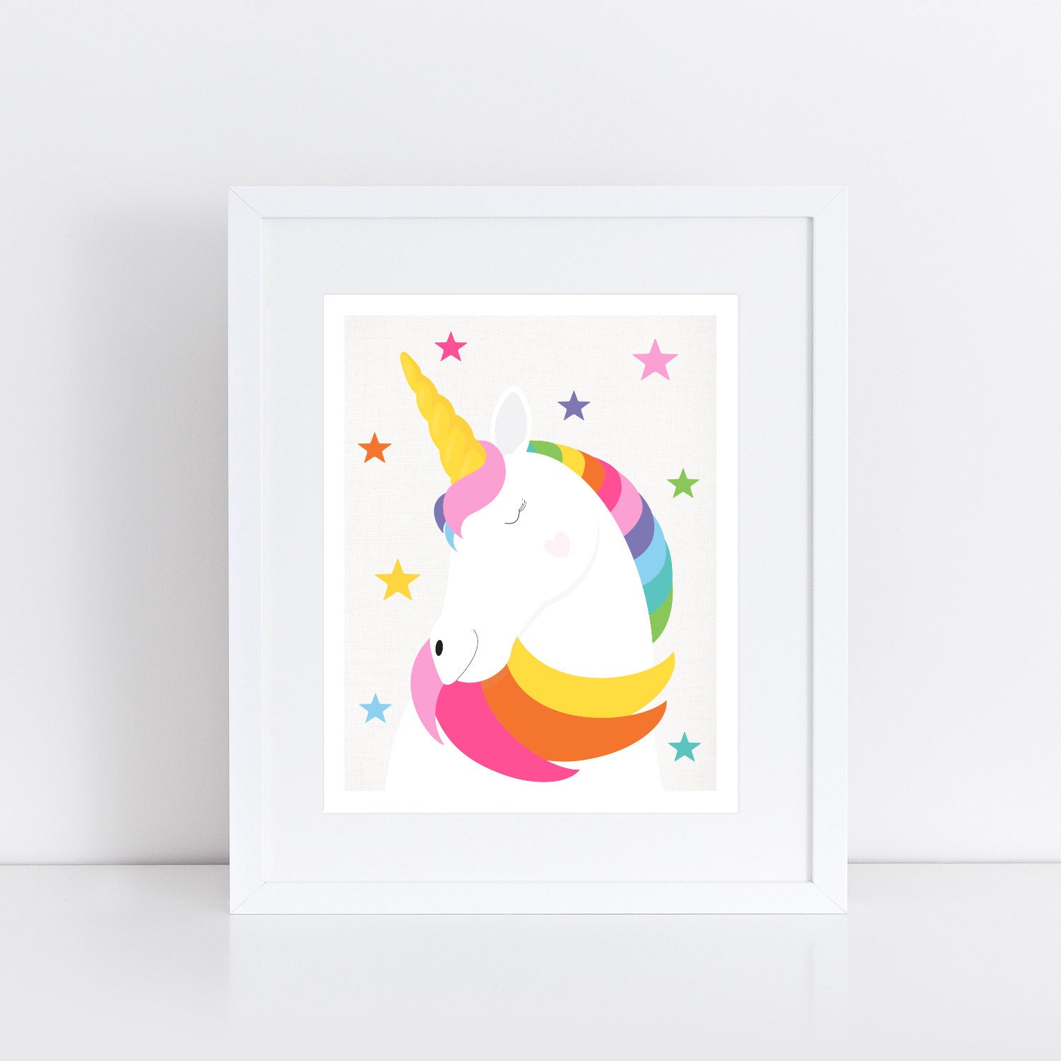 unicorn illustration in rainbow colours and a scattering of stars