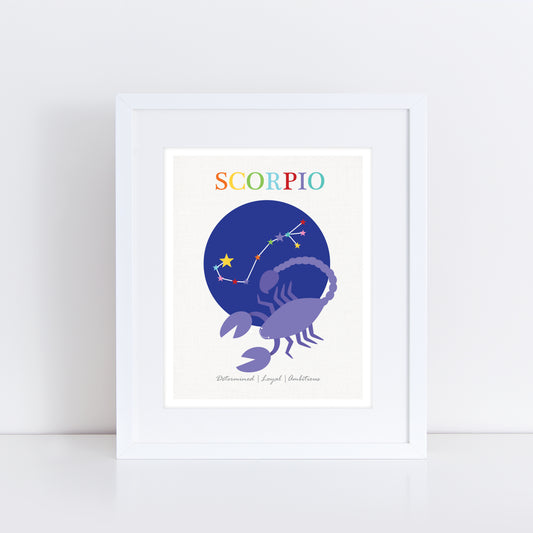 Framed Scorpio zodiac art print featuring a purple scorpion with a constellation illustration against a deep blue circular background. The word 'Scorpio' is written at the top in colorful letters, with the traits 'Determined | Loyal | Ambitious' listed below. The print is displayed in a white frame.