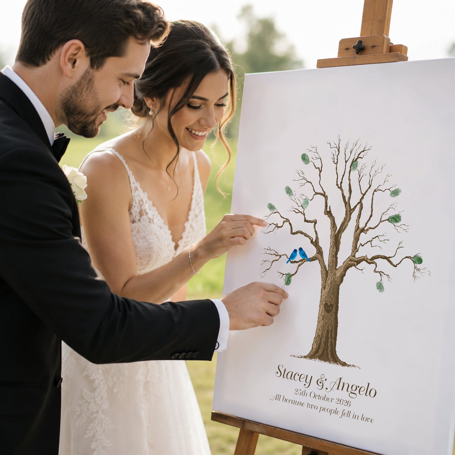 Colourful fingerprint wedding guest book alternative poster with bride and groom adding fingerprints to personalised tree artwork at outdoor wedding reception