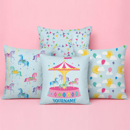 Pastel carnival themed cushion featuring a personalised carousel cushion at the front, carousel horse and balloon pattern cushions on either side, and a colourful bunting pattern cushion at the back.