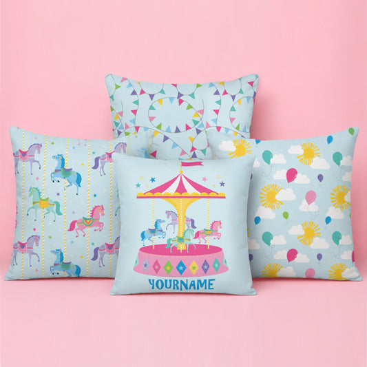 Pastel carnival themed cushion featuring a personalised carousel cushion at the front, carousel horse and balloon pattern cushions on either side, and a colourful bunting pattern cushion at the back.