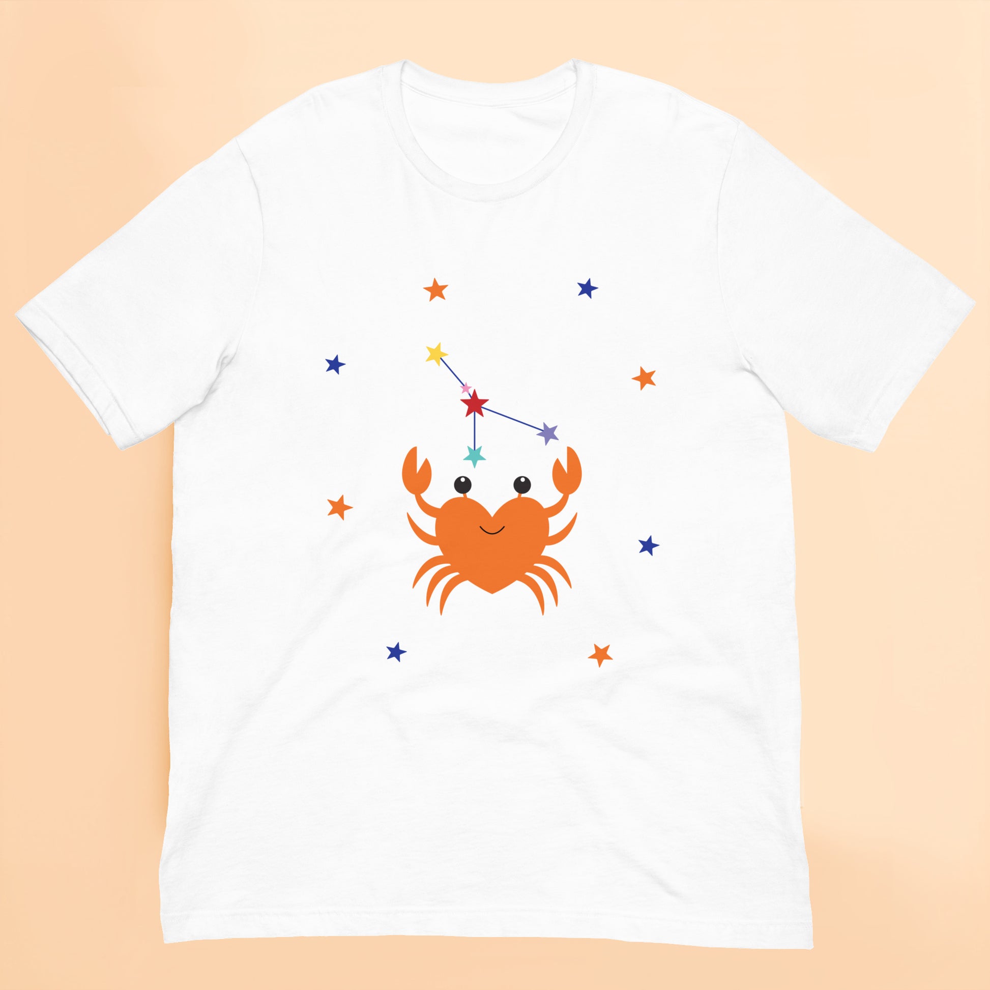 White t-shirt with a cancer crab and star constellation design on a peach background