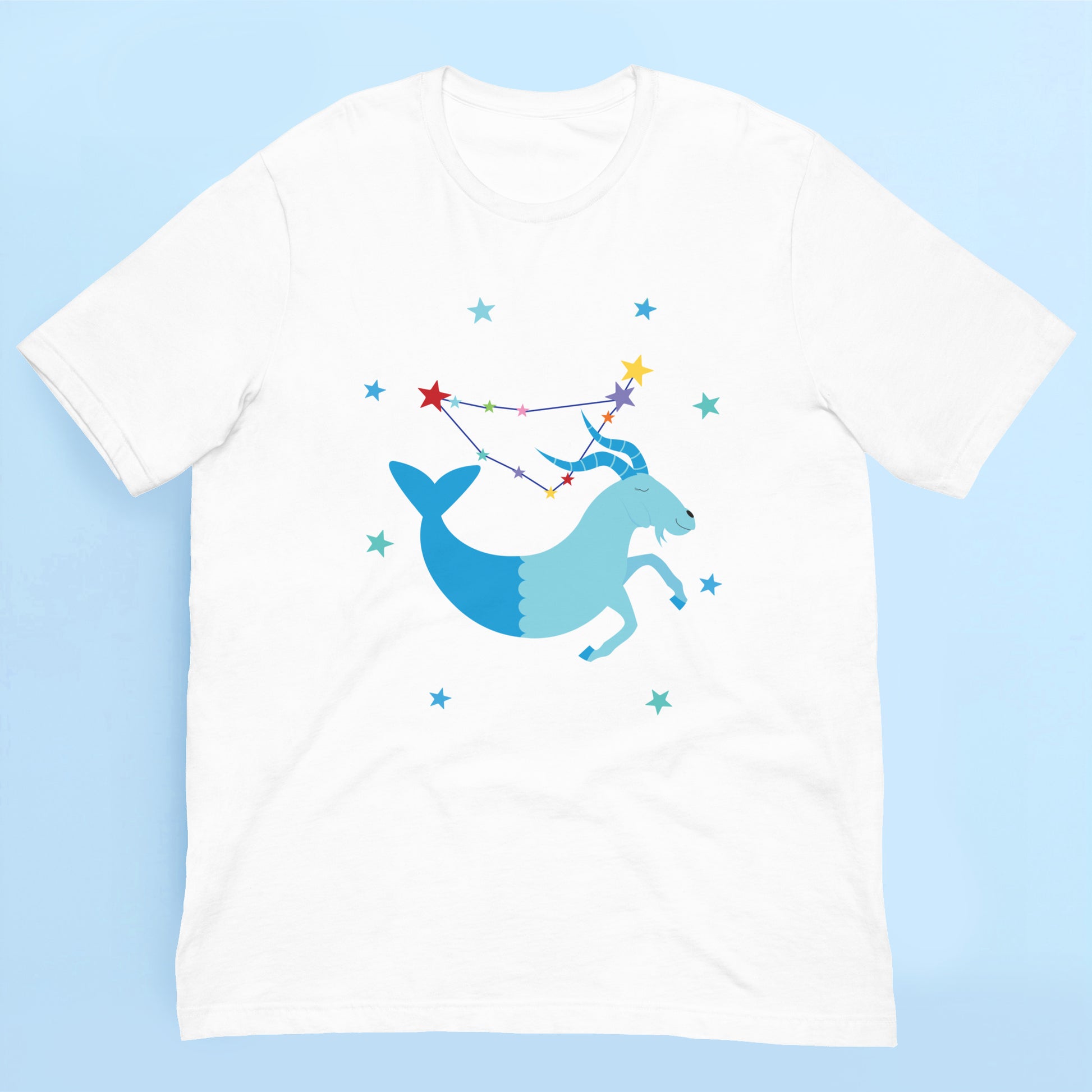White t-shirt with a capricorn and star constellation design on a light blue background