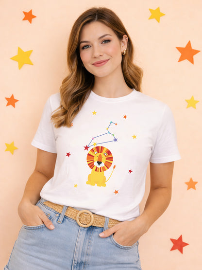 Woman wearing a white t-shirt with a leo lion graphic and star constellation on a peach background with colorful stars.