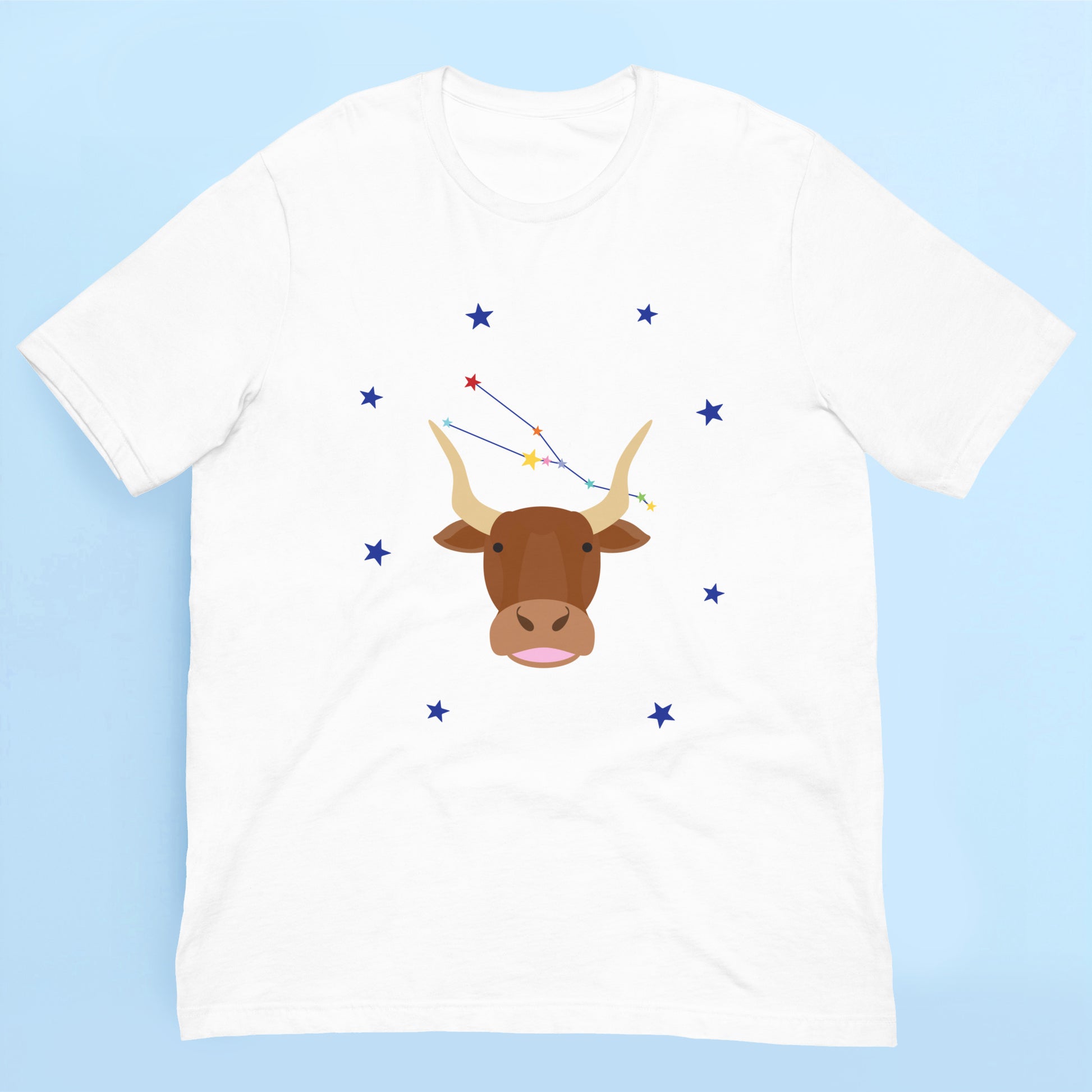White t-shirt with a taurus bull and star constellation design on a light blue background