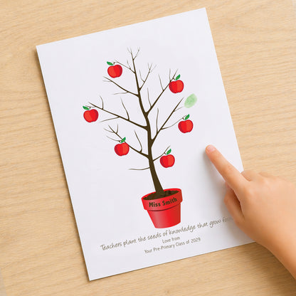 Teacher fingerprint tree print on desk with child hand adding fingerprint, personalised teacher gift idea