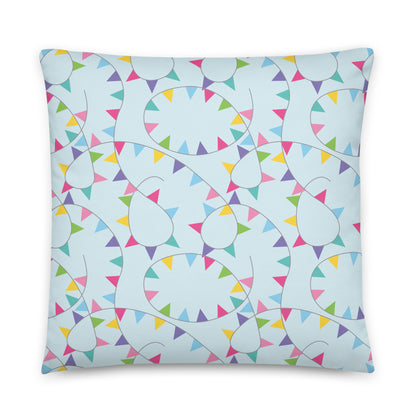 Decorative pillow with colorful bunting pattern on a light blue background