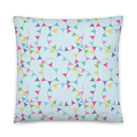 Decorative pillow with colorful bunting pattern on a light blue background