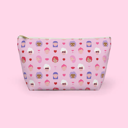 Colourful Galentine themed accessory pouch featuring illustrated women, hearts and champagne glasses on a pink background with a gold zipper and flat bottom design by Creative Monsoon.