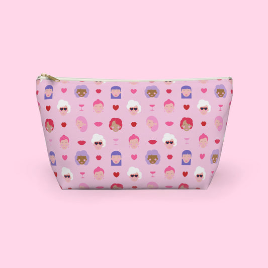 Colourful Galentine themed accessory pouch featuring illustrated women, hearts and champagne glasses on a pink background with a gold zipper and flat bottom design by Creative Monsoon.