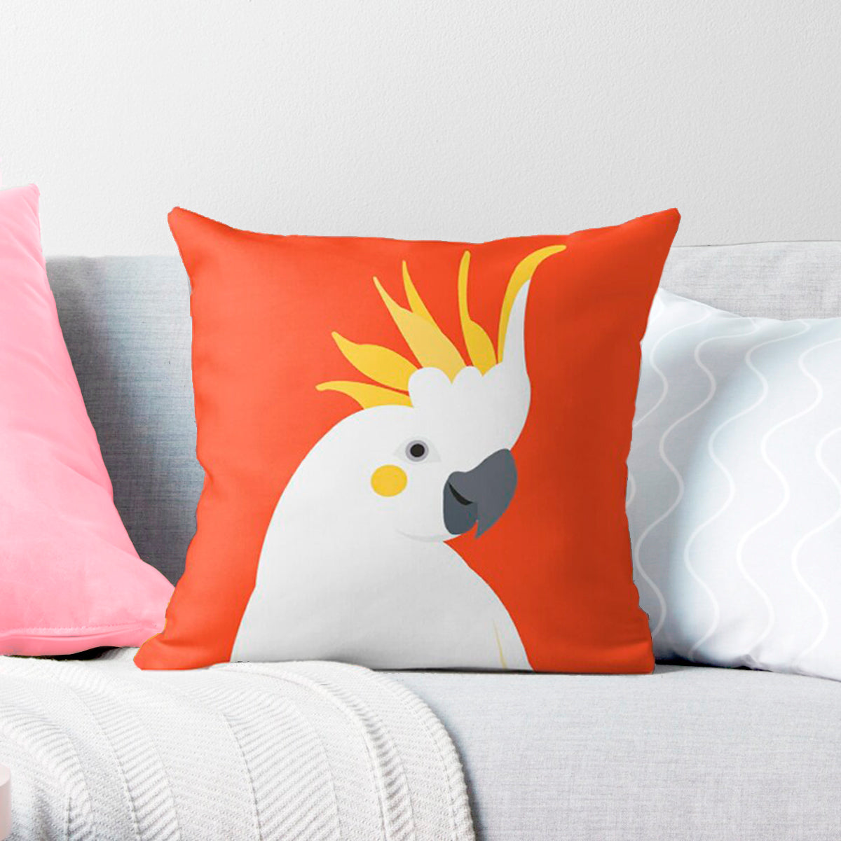 gorgeous Australian cockatoo cushion cover with bold orange background sitting on a couch