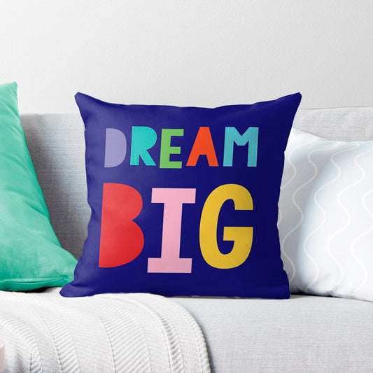 cute cushion cover with a bold and bright 'DREAM BIG'  on a couch