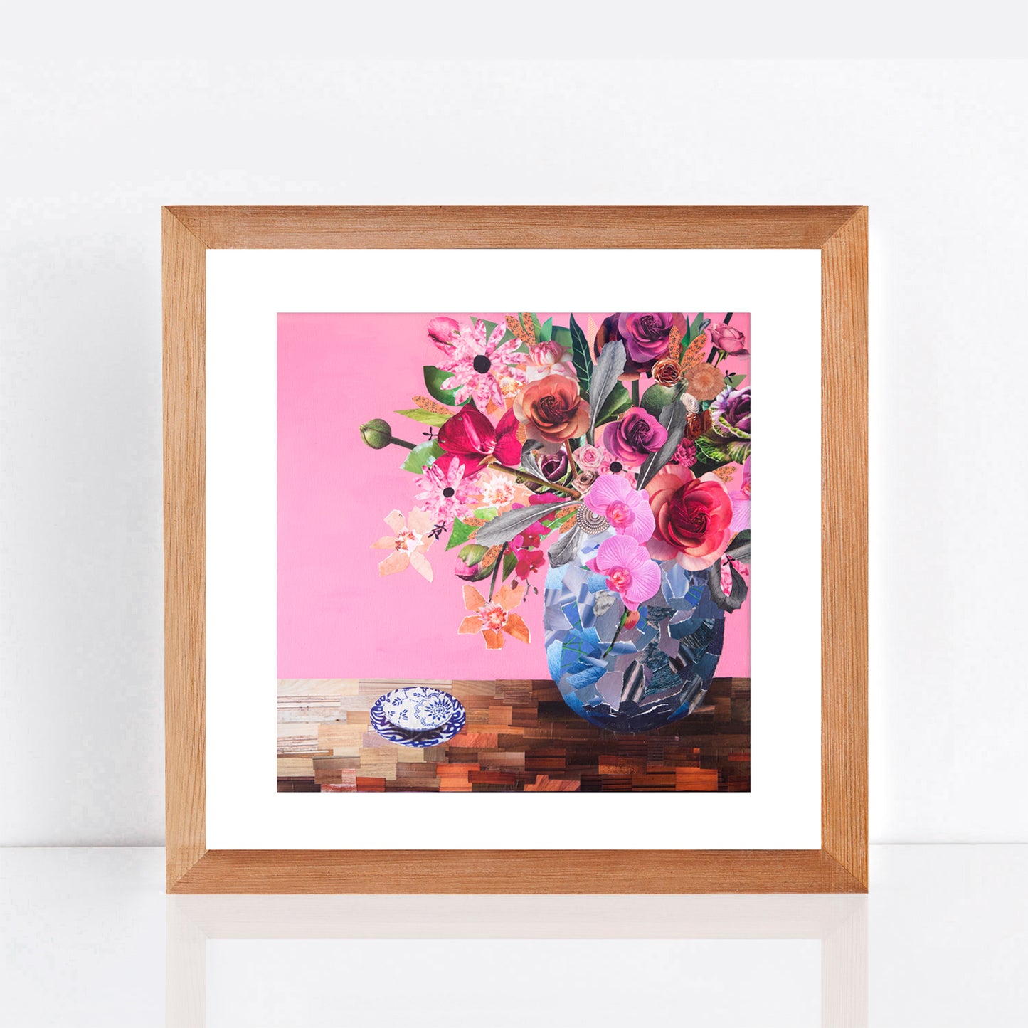 print in frame of a collage artwork made from magazine scraps, vintage botanicals and flower photography with pink background