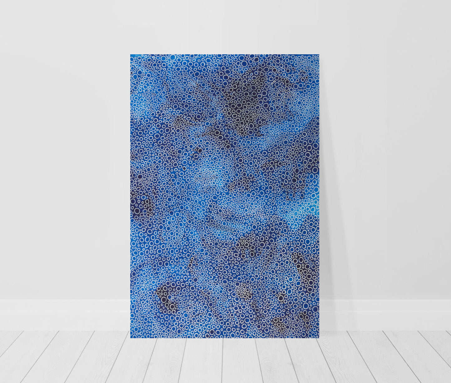 canvas print in room of abstract painting in blue with white circles