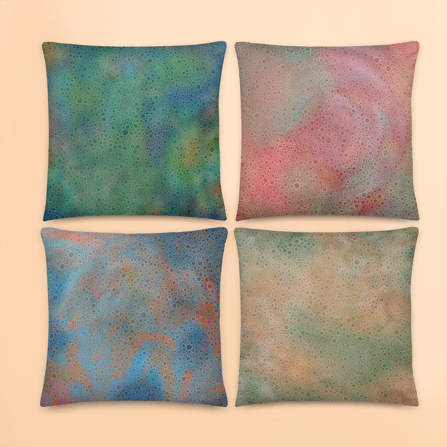 Set of four tropical abstract cushion covers featuring layered circular artwork patterns in green, coral, blue and sandy neutral tones.