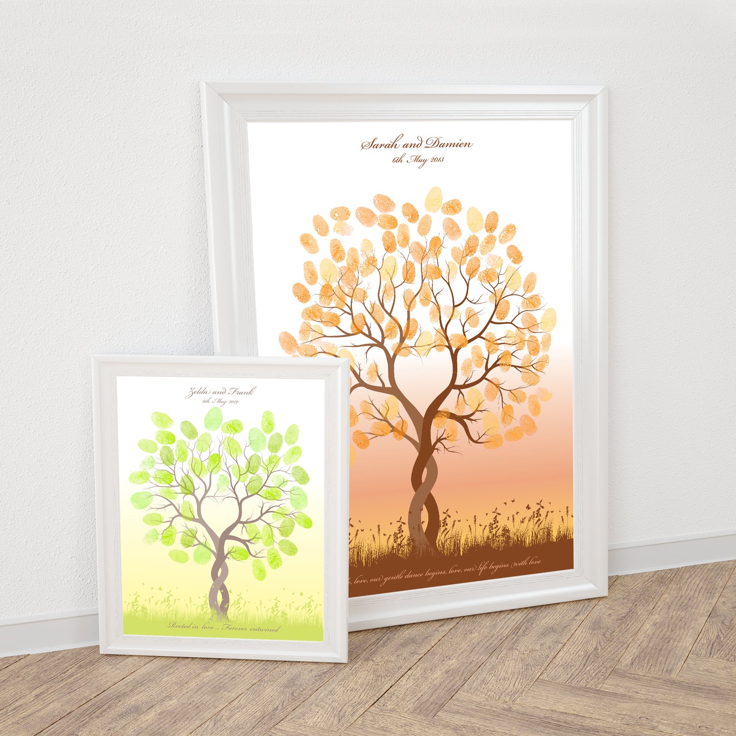 two fingerprint guestbook trees in frames against a wall
