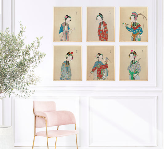 chinoiserie prints with portraits of female performers of the Peking Opera on a white wall near pink chair