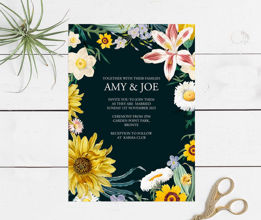 black invitation with floral design around the outside
