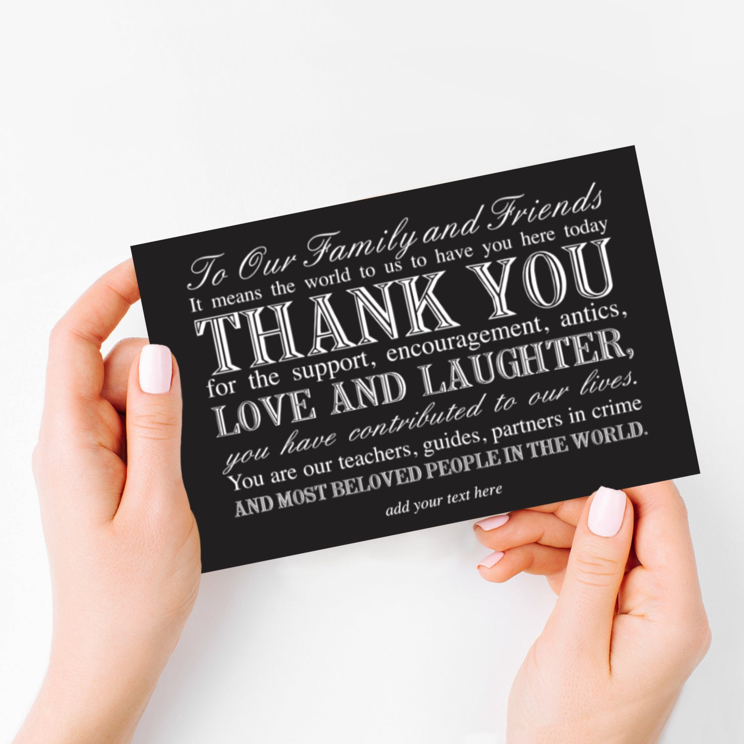 hands holding classic black and white typography wedding reception thank you card creating a timeless and sophisticated look