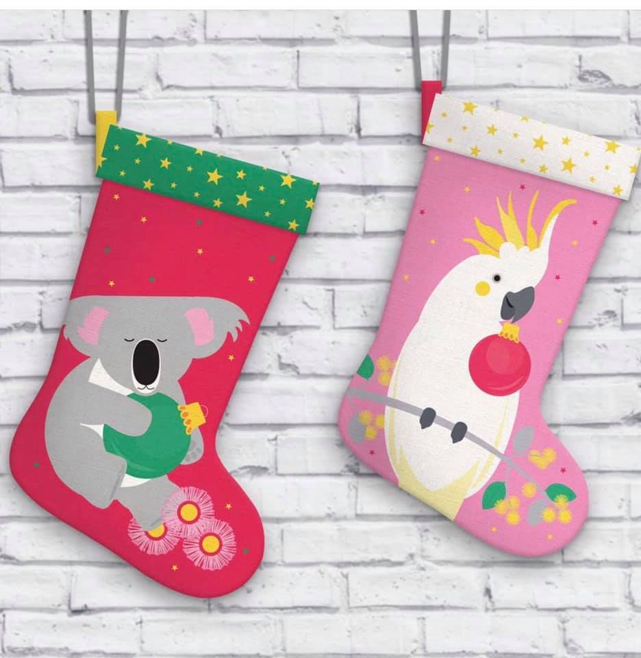 Australian themed Christmas Stockings hanging up, red and green with a koala and pink with a cockatoo