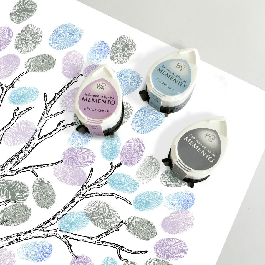 set of fingerprint tree ink pads, blue, purple and grey sitting on a fingerprint guestbook tree